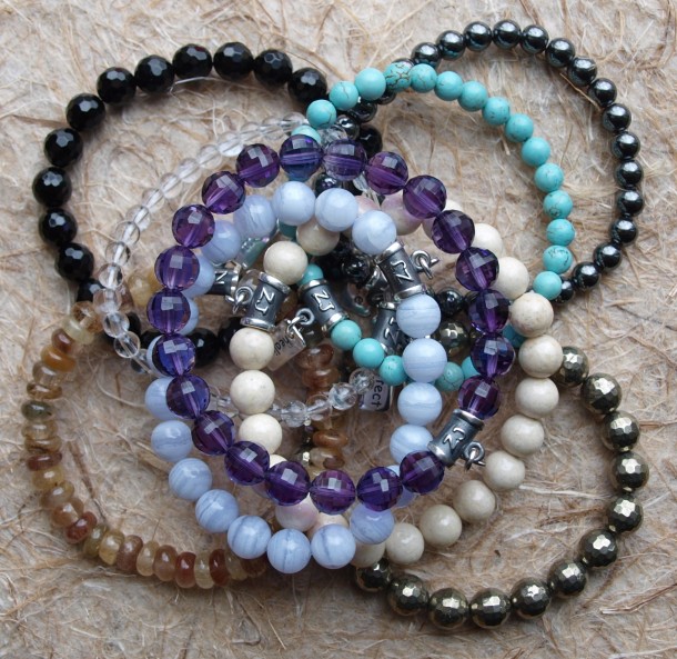 Assorted healing crystal bracelets made with natural gemstones by zen jewelz