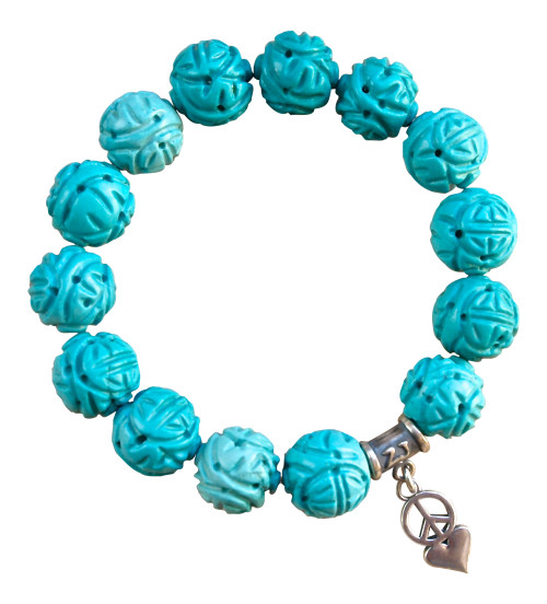 Carved Turquoise gemstone bracelet adorned with a sterling silver heart and peace charm - turquoise healing properties